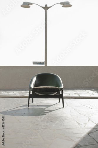 Photo: Armchair sitting on rooftop patio Armchair sitting on rooftop patio