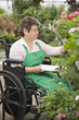 Caucasian worker in wheelchair working in nursery