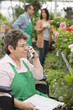 Caucasian worker in wheelchair working in nursery