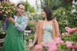 Florist helping customer in nursery