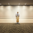 Mixed race businessman standing at podium