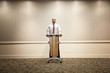 Mixed race businessman standing at podium