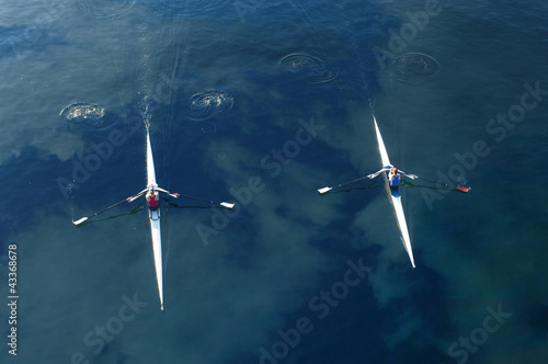 Photo: People rowing sculling boats on river People rowing sculling boats on river