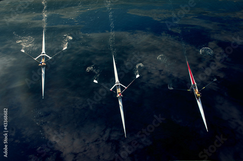 Photo: People rowing sculling boats on river People rowing sculling boats on river