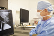 Surgeon looking at skull x-ray