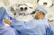 Caucasian doctor operating in operating room