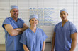 Doctors standing next to schedule whiteboard in hospital