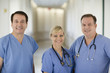 Smiling doctors standing in hospital corridor