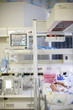 Hispanic baby in warming bassinet in hospital