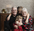Caucasian grandparents sitting with granddaughters