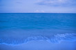 Waves on beach of tranquil blue ocean