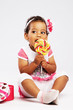 Lovely little girl eating a big lollipop