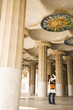 Tourist photographing ceiling of ornate building