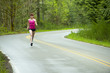 Mixed race woman running on remote road