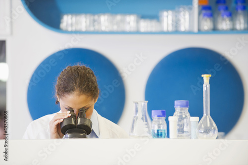 Photo: Mixed race scientist working in laboratory Mixed race scientist working in laboratory