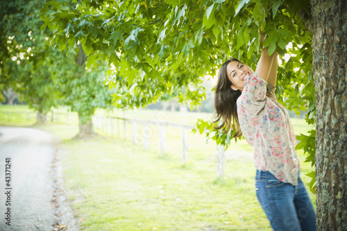 Photo: Hispanic woman climbing tree Hispanic woman climbing tree