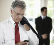 Caucasian businessman text messaging on cell phone