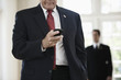 Caucasian businessman text messaging on cell phone