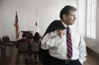 Hispanic businessman standing in meeting room