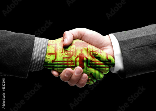 Photo: hand shake of two leaders with technology hand shake of two leaders with technology