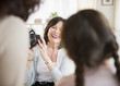 Woman taking picture of daughter and granddaughter