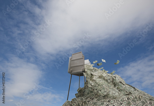 Photo: Money overflowing from voting booth Money overflowing from voting booth