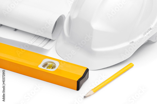 Photo: White hard hat is near level, druft and pencil on white White hard hat is near level, druft and pencil on white