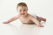 Caucasian baby boy laying on ground