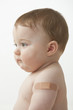 Caucasian baby boy with bandage on arm