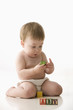 Mixed race baby boy playing with alphabet blocks