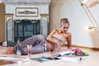 young woman sitting and reading magazine indoor shot