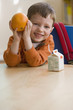 Caucasian boy eating snack in classroom