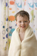 Caucasian boy wrapped in a towel
