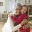 Caucasian grandmother and granddaughter hugging