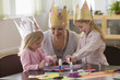 Caucasian grandmother and granddaughters doing arts and crafts together