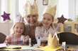 Caucasian grandmother and granddaughters doing arts and crafts together