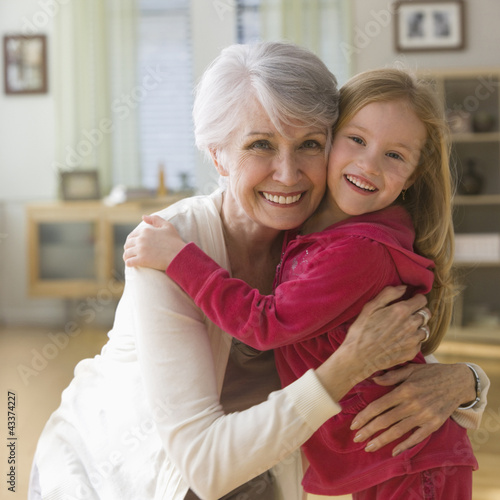 Photo: Caucasian grandmother and granddaughter hugging Caucasian grandmother and granddaughter hugging