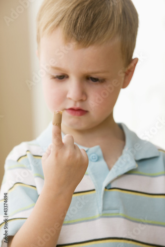 Photo: Caucasian boy with bandage on finger Caucasian boy with bandage on finger