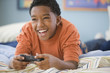 Mixed race boy playing video game