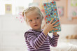 Caucasian girl holding birthday gift
