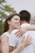 Hispanic couple hugging outdoors