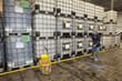 Hispanic worker cleaning floor in warehouse