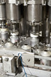Close up of metal bottles on assembly line