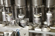 Close up of metal bottles on assembly line