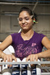 Hispanic worker holding cans on assembly line