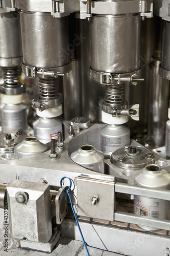 Photo: Close up of metal bottles on assembly line Close up of metal bottles on assembly line
