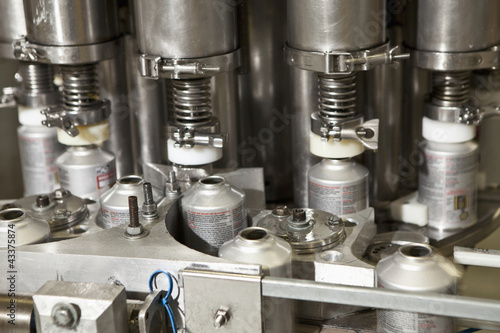 Photo: Close up of metal bottles on assembly line Close up of metal bottles on assembly line