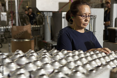 Photo: Hispanic woman working on assembly line Hispanic woman working on assembly line