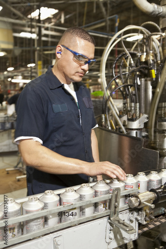 Photo: Hispanic man working on assembly line Hispanic man working on assembly line