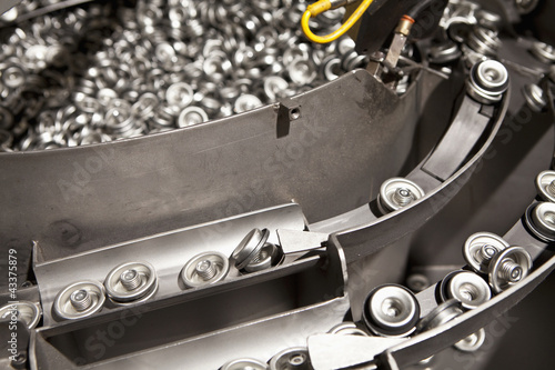 Photo: Metal can tops on assembly line Metal can tops on assembly line